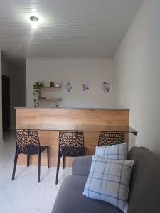 una sala de estar con un sofá, una mesa y sillas en Vila Velho Chico, en Bom Jesus da Lapa