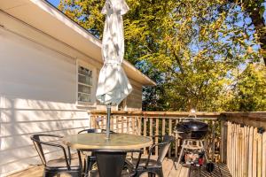 a table and chairs on a deck with a grill at Dual-Family Retreat Sunlit Haven in Columbus