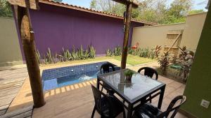 un patio con tavolo e sedie accanto alla piscina di Chales da Kitanda Petit a Teresina