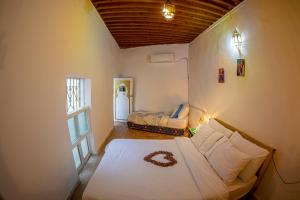 Ένα ή περισσότερα κρεβάτια σε δωμάτιο στο Dar Mohamadia