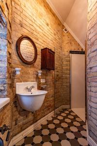 a bathroom with a sink and a mirror at Apartamenty Carskie in Białowieża