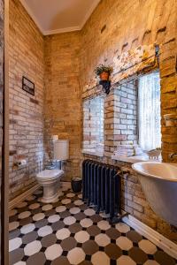 a bathroom with a sink and a tub and a toilet at Apartamenty Carskie in Białowieża +111 photos