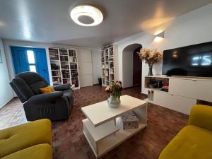 a living room with two chairs and a tv at Villa Emma in Lanišće