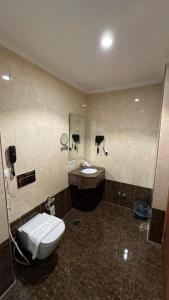 a bathroom with a toilet and a sink at فندق الشهباء الفيحاء Hotel Al Shahba Al Faiha Jeddah in Jeddah