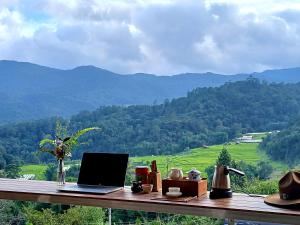 un ordenador portátil sobre una mesa de madera en ดิ เอสเคปอินทนนท์ - The Escape Inthanon, en Ban Yang