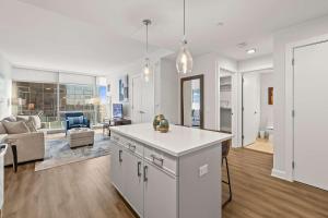 a kitchen and living room with a couch and a table at Luxury Modern Apartment Near Stamford Station in Stamford +9 photos