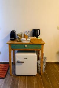 a wooden table with a small table with a refrigerator under it at B&B Lilla All'Adige in Legnago