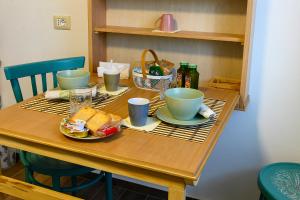 a table with bowls and plates of food on it at B&B Lilla All'Adige in Legnago