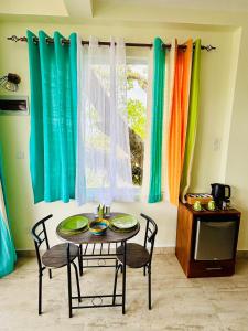 a table and chairs in front of a window at Dinewa Apartment in Aluthgama