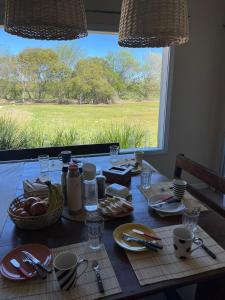 a table with food and a view of a field at Posada El Descanso in Mercedes +1 photo