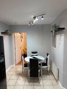 a dining room with a table and chairs at Stylish 3 BR home & Game room & Family Lounge in Dudley