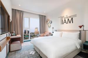 a hotel room with a bed and a large window at Rove Healthcare City - Bur Dubai in Dubai