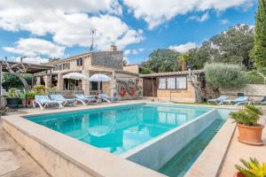 a swimming pool in the backyard of a house at Finca Son Matginet in Sineu