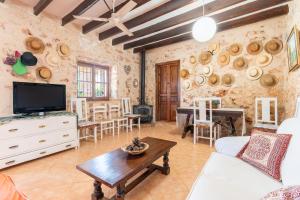 a living room with a tv and a table at Finca Son Matginet in Sineu