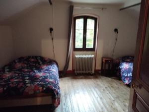 a bedroom with a bed and a window at Pause détente in Saint-Bonnet-Avalouse +10 photos