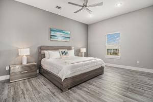 a bedroom with a bed and a ceiling fan at Luxury Beachfront Family Fun Sleeps 22 in Surfside Beach