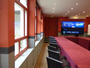 a conference room with a long table and chairs at Cit'Hotel Escatel in Mâcon