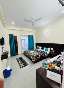 a bedroom with two beds and a table with water bottles at Aman Nest in Jāmb +1 photo