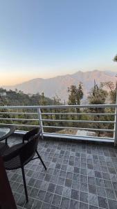 a patio with a table and a chair on a balcony at Aman Nest in Jāmb
