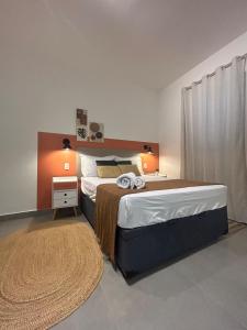 une chambre avec un grand lit et un tapis dans l'établissement Compact Home Campinas, à Campinas