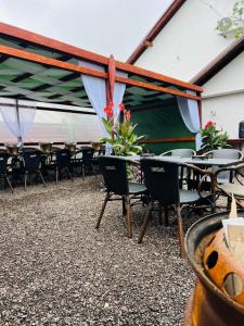 a group of tables and chairs under a tent at Cinema Villa Elena #1 in Dancu