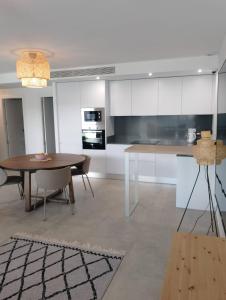 a kitchen with a table and a dining room at Iconic Zuza in Gran Alacant