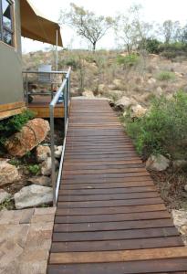 a wooden walkway leading to a porch of a house at Tierpoort Barn in Mountain in Tierpoort +7 photos