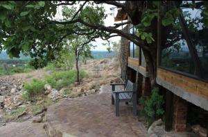 a bench sitting on a brick walkway next to a building at Tierpoort Barn in Mountain in Tierpoort