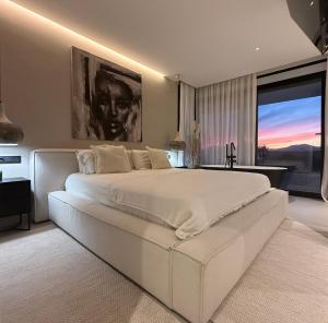 a bedroom with a large white bed with a large window at Casa Troia in Alhaurín de la Torre +58 photos