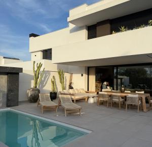 a house with a swimming pool next to a house at Casa Troia in Alhaurín de la Torre