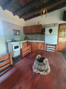 a kitchen with a wooden table and a kitchen with a stove at Espacio Colibrí in San Francisco del Monte de Oro