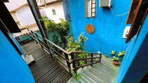 a blue building with a staircase leading up to a house at Pousada Mandala - Búzios in Búzios