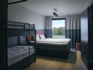 two bunk beds in a room with a window at Stopover Falkenberg in Falkenberg