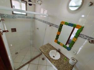 a bathroom with a sink and a glass shower at Pousada Mandala - Búzios in Búzios +53 photos