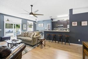 a living room with a couch and a kitchen at Castaway Cove | Palm Coast in Palm Coast