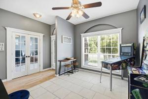 a living room with a ceiling fan and a table at Castaway Cove | Palm Coast in Palm Coast