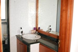 a bathroom with a sink and a mirror at Valle holiday casa vacanza in Locorotondo +12 photos