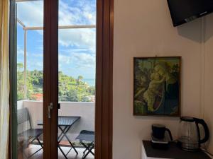 a door to a room with a painting of a woman holding a child at Affittacamere Alle 5 Terre in Monterosso al Mare