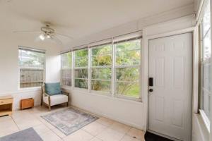a room with a door and a chair and windows at West Palm Beach Hideaway J2A in Lantana