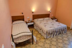 a hotel room with two beds and two tables at A casa dei miei 