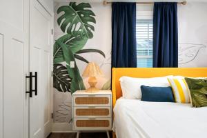 a bedroom with a bed with a yellow headboard at Downtown Retreat, 5BR Game Room & Pet Friendly in Wilmington