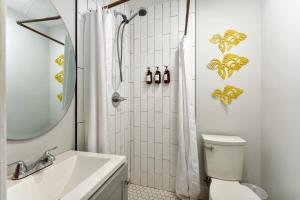 a bathroom with a shower and a toilet and a sink at Downtown Retreat, 5BR Game Room & Pet Friendly in Wilmington +43 photos