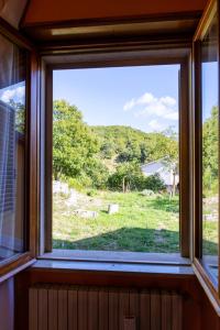 a window in a room with a view of a field at A casa dei miei in Castelluccio