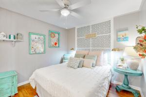 a bedroom with a white bed and a blue table at Stunning Beachfront Beach Access Dog Haven in Hercules Offshore Heliport