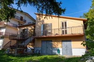 an apartment building with a balcony and a staircase at A casa dei miei in Castelluccio