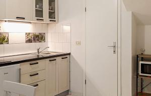 Nice Apartment In Podgora With Wifi في Kržanići: مطبخ بخزائن بيضاء ومغسلة