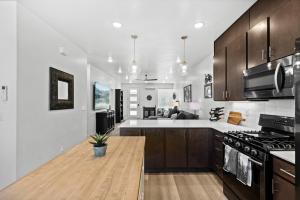 a kitchen with wooden cabinets and a counter top at New 4 bed 3 and half bath with pool, hot tub, waterslide and PS5 in Saint George Municipal Airport
