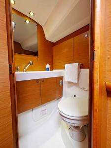a small bathroom with a toilet and a sink at Unique Yacht Stay Near Historic Valletta in Tal-Pietà