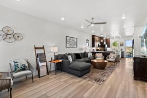 a living room with a couch and a table at New 4 bed 3 and half bath with pool, hot tub, waterslide and PS5 in Saint George Municipal Airport
