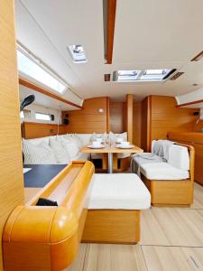 a room with a table and chairs in a boat at Unique Yacht Stay Near Historic Valletta in Tal-Pietà